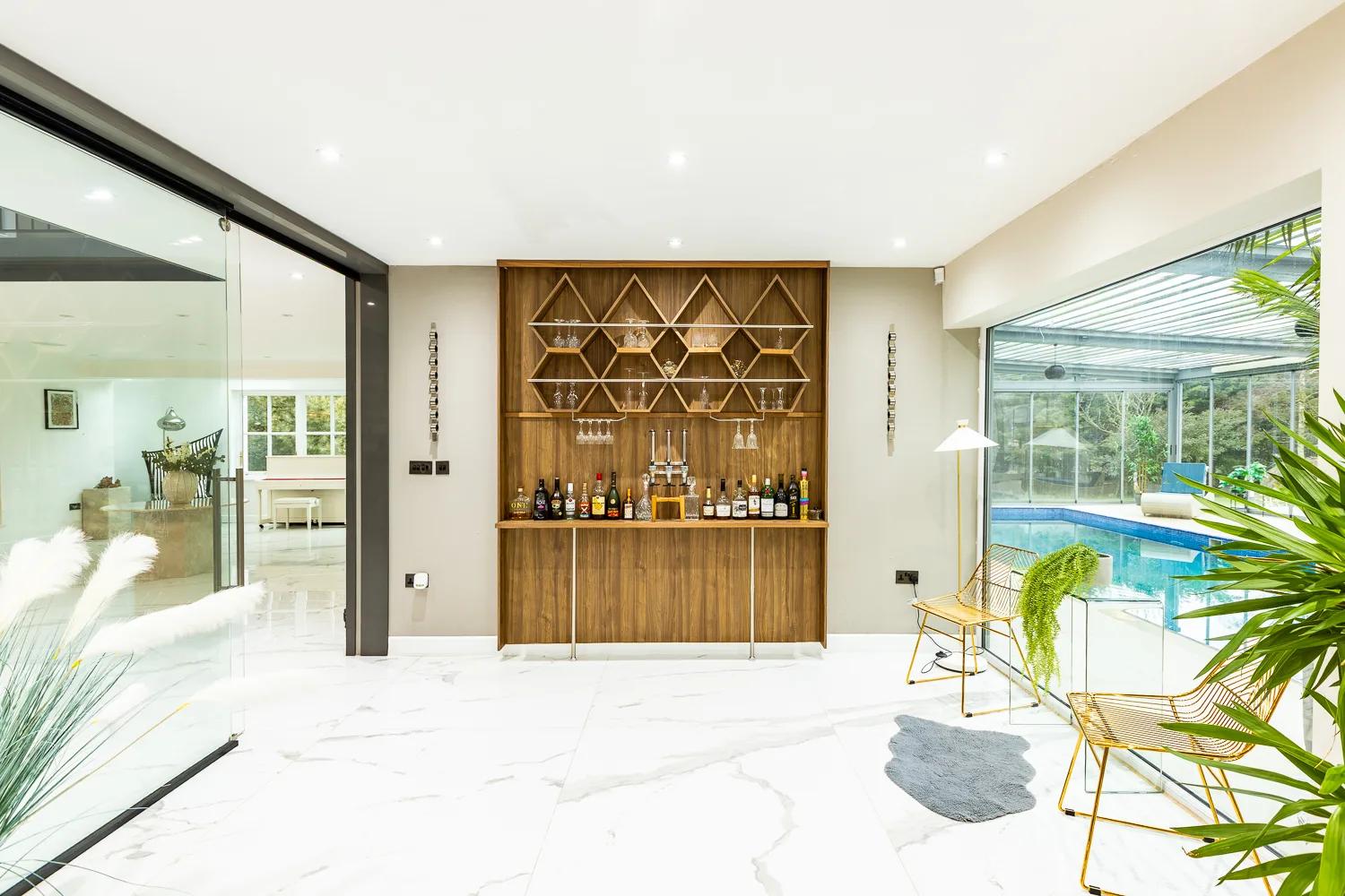 The walnut cocktail bar beside the pool