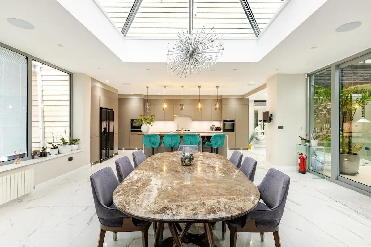 The garden room — oval dining table under the glass lantern roof