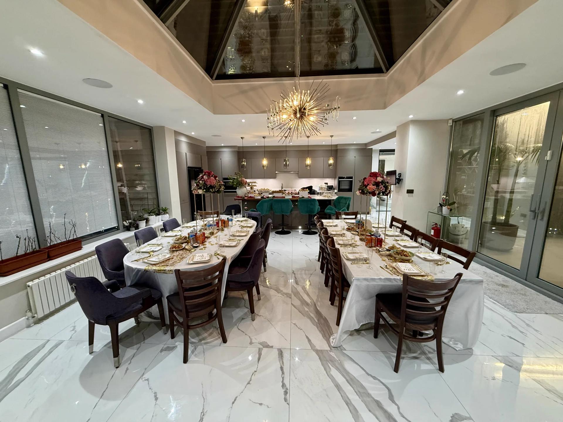 Garden Room set for dinner: long dressed table under the glass lantern